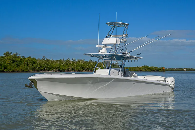 Slide: The Image of 2019 Bahama 41 boat on calm water under clear blue sky. - 5