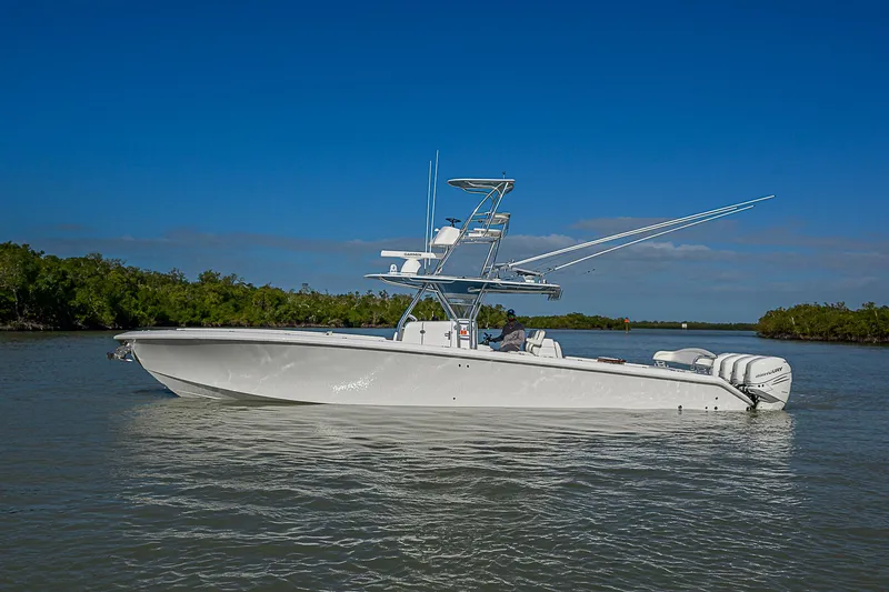 Slide: The Image of 2019 Bahama 41 boat on calm water under clear blue sky. - 6