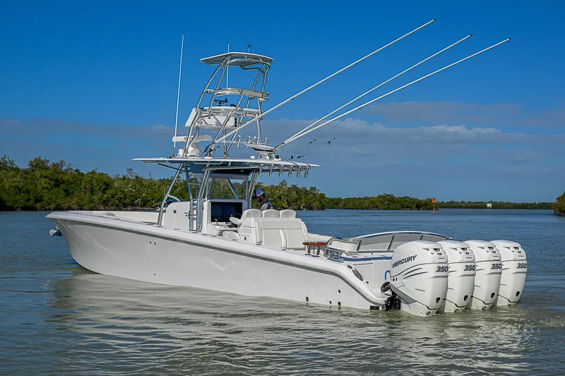 Slide: The Image of 2019 Bahama 41 boat with four Mercury engines on calm water. - 7