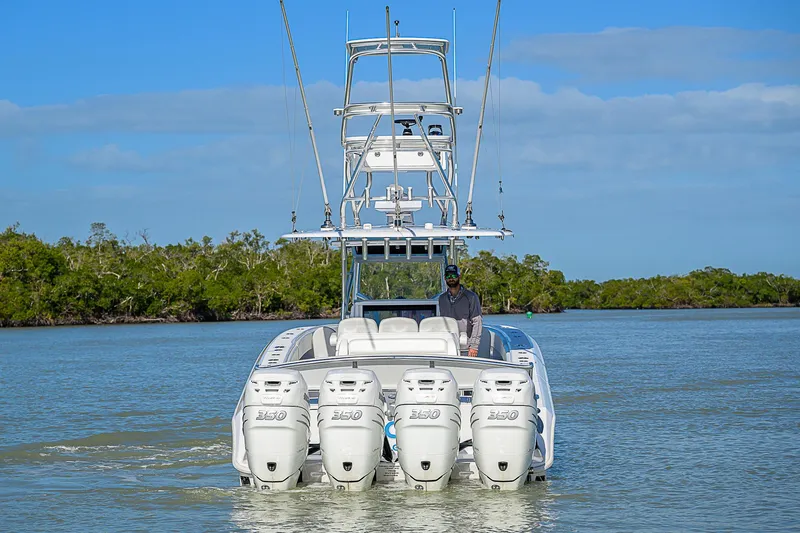 Slide: The Image of 2019 Bahama 41 boat with four engines cruising on a calm river. - 8