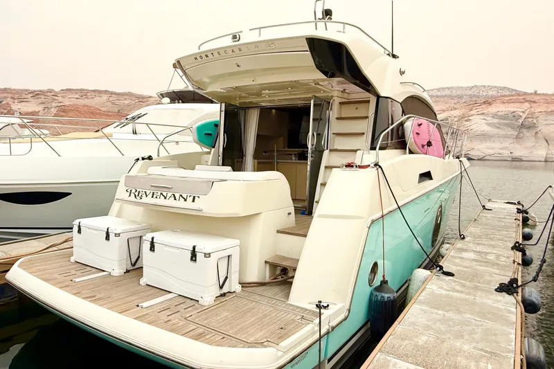 Slide: The Image of 2015 Monte Carlo MC5S yacht docked, featuring spacious deck and modern design. - 0