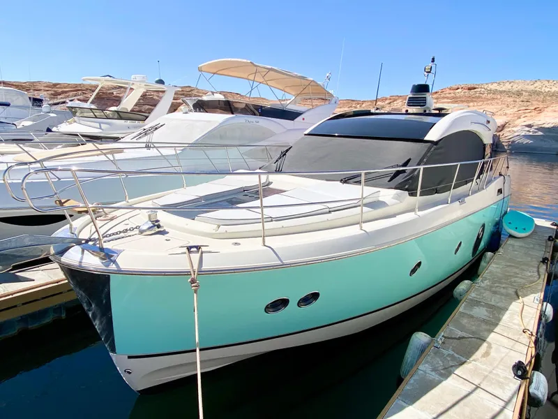 Slide: The Image of Monte Carlo MC5S 2015 yacht docked, featuring sleek design and turquoise hull. - 1