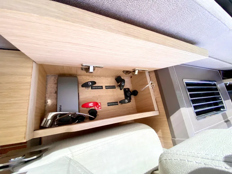 Slide: The Image of Open storage compartment in 2015 Monte Carlo MC5S with keys and sunglasses. - 17