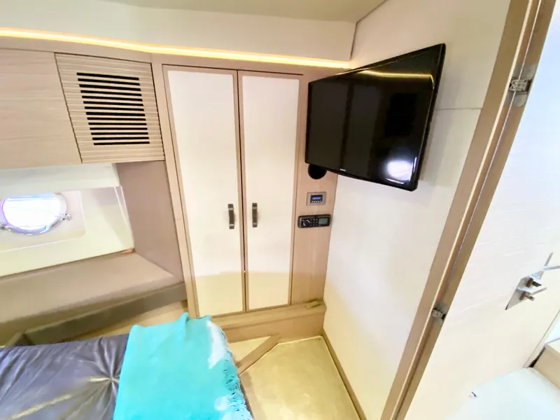 Slide: The Image of Luxurious 2015 Monte Carlo MC5S cabin interior with TV and wardrobe. - 27