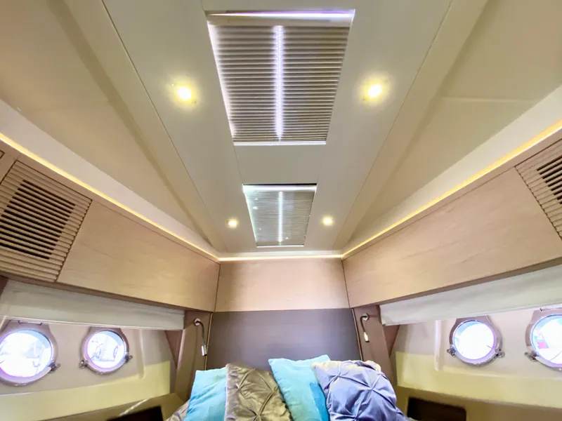 Slide: The Image of Luxurious 2015 Monte Carlo MC5S yacht cabin interior with skylights and portholes. - 28