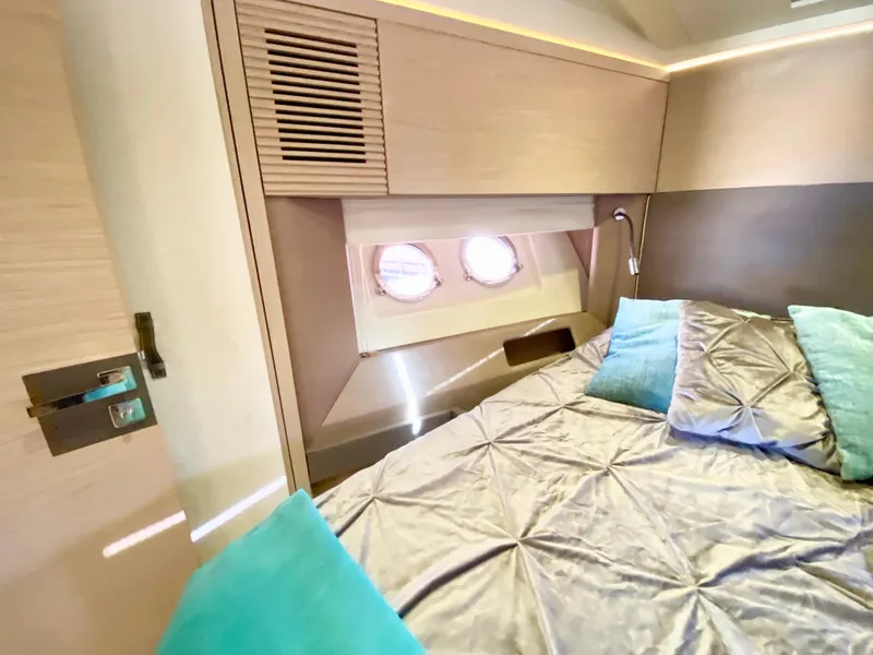 Slide: The Image of Luxurious bedroom interior of 2015 Monte Carlo MC5S yacht with elegant bedding and porthole windows. - 29