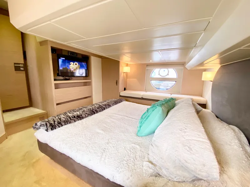 Slide: The Image of Luxurious 2015 Monte Carlo MC5S yacht bedroom with modern decor and circular window view. - 38