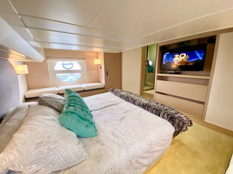 Slide: The Image of Luxurious 2015 Monte Carlo MC5S yacht bedroom with cozy bed, TV, and porthole window. - 41