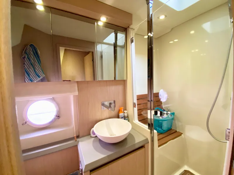 Slide: The Image of Luxurious bathroom in 2015 Monte Carlo MC5S yacht with modern fixtures and porthole window. - 44
