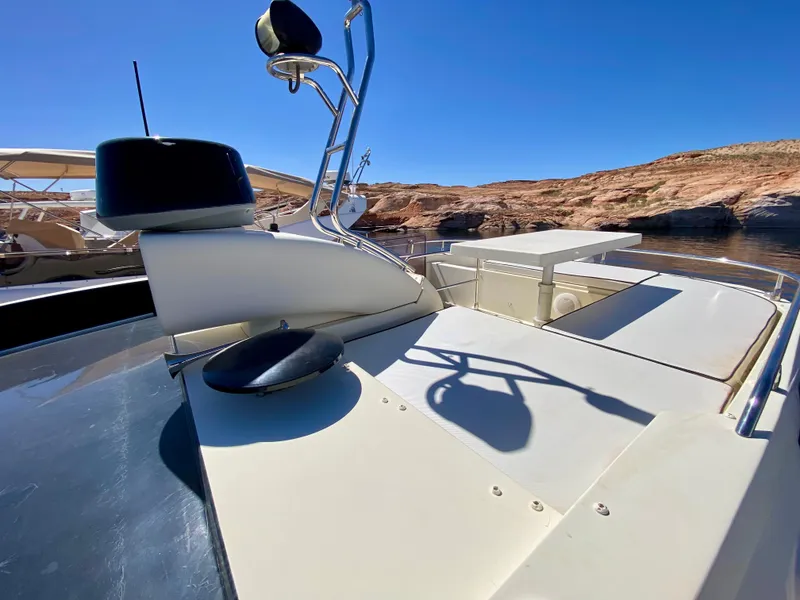 Slide: The Image of Monte Carlo MC5S 2015 yacht deck with clear blue sky and rocky shoreline. - 48