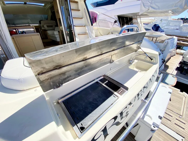 Slide: The Image of Outdoor kitchen on 2015 Monte Carlo MC5S yacht, featuring stainless steel grill and counter. - 6