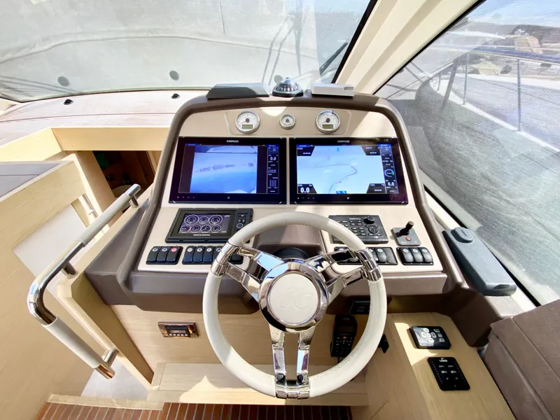 Slide: The Image of 2015 Monte Carlo MC5S yacht helm with dual navigation screens and modern controls. - 15