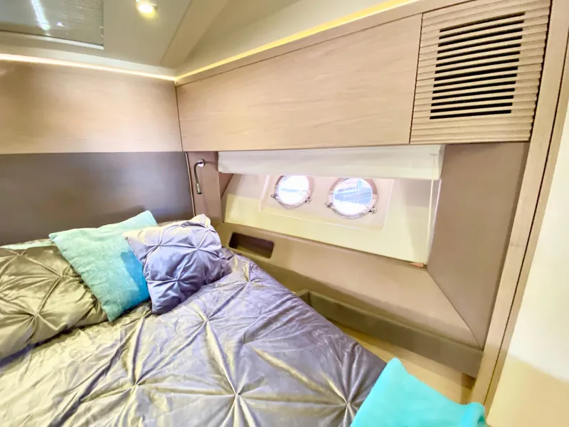 Slide: The Image of Luxurious bedroom interior of 2015 Monte Carlo MC5S yacht with elegant bedding and porthole windows. - 30