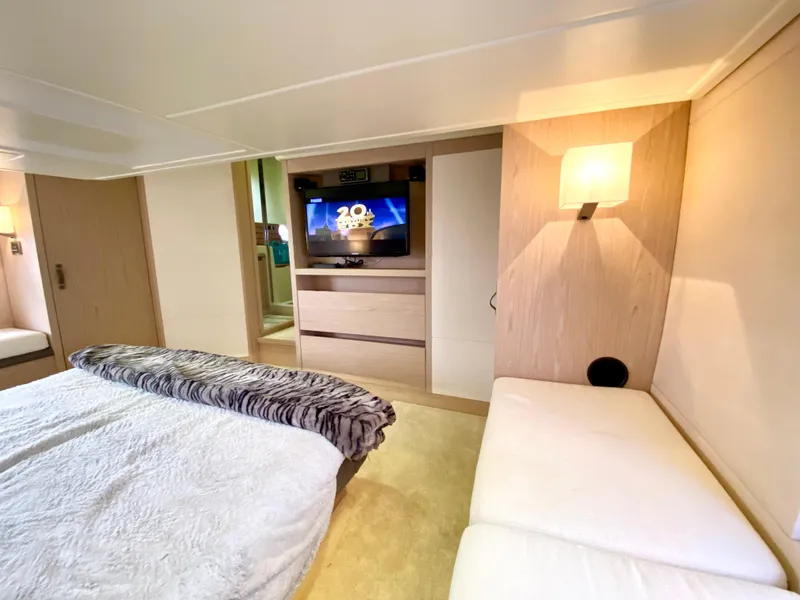 Slide: The Image of Luxurious 2015 Monte Carlo MC5S yacht bedroom with TV, cozy bed, and modern lighting. - 40