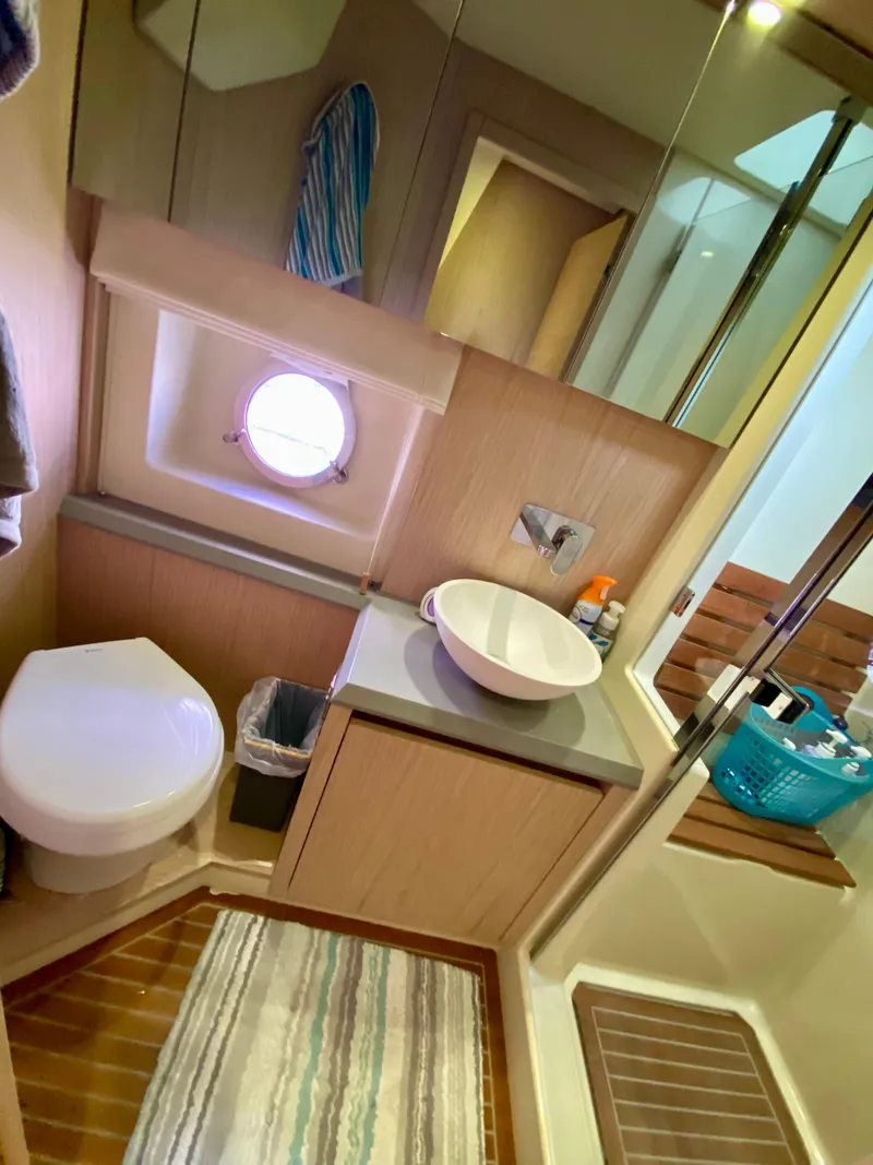 Slide: The Image of Luxurious 2015 Monte Carlo MC5S yacht bathroom with modern fixtures and porthole window. - 45