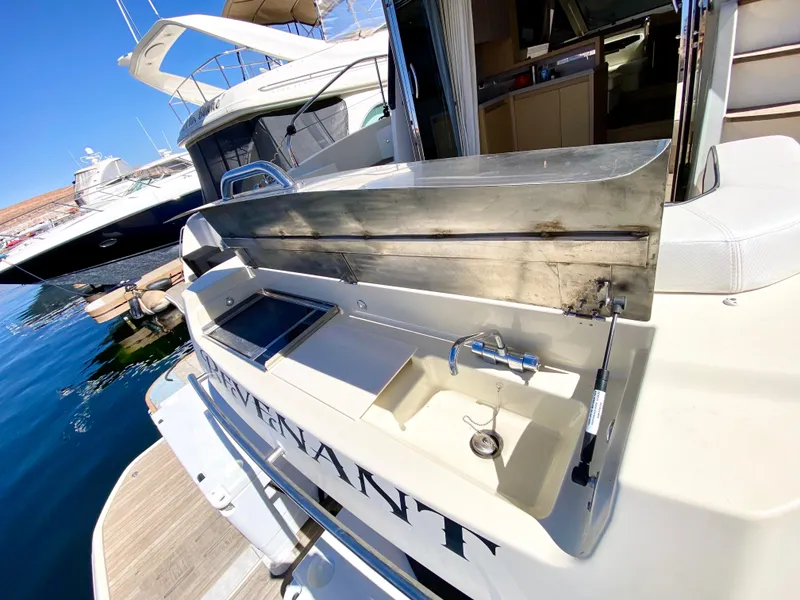 Slide: The Image of Luxury Monte Carlo MC5S yacht with outdoor sink and grill, docked at marina, 2015 model. - 5