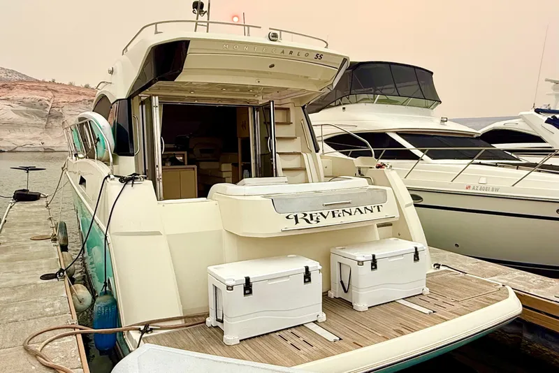 Slide: The Image of Luxury Monte Carlo MC5S yacht docked, 2015 model, with open deck and scenic backdrop. - 61