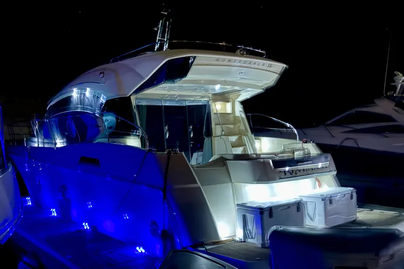 Slide: The Image of Luxurious 2015 Monte Carlo MC5S yacht illuminated at night with blue LED lights. - 62