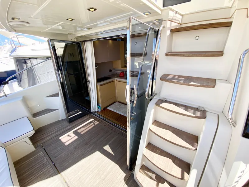 Slide: The Image of 2015 Monte Carlo MC5S yacht interior with stairs, open doors, and modern design. - 8