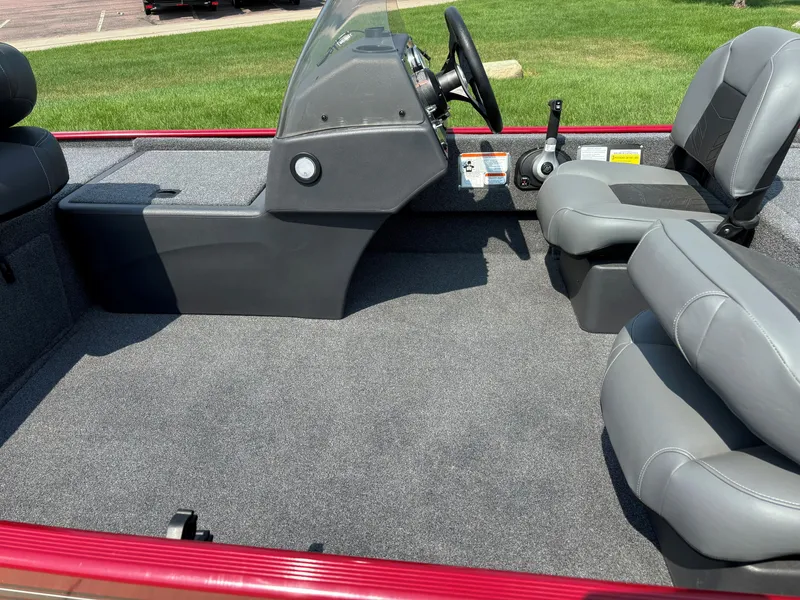 Slide: The Image of 2024 Tracker Bass Tracker Classic XL boat interior with gray seating and steering console. - 5
