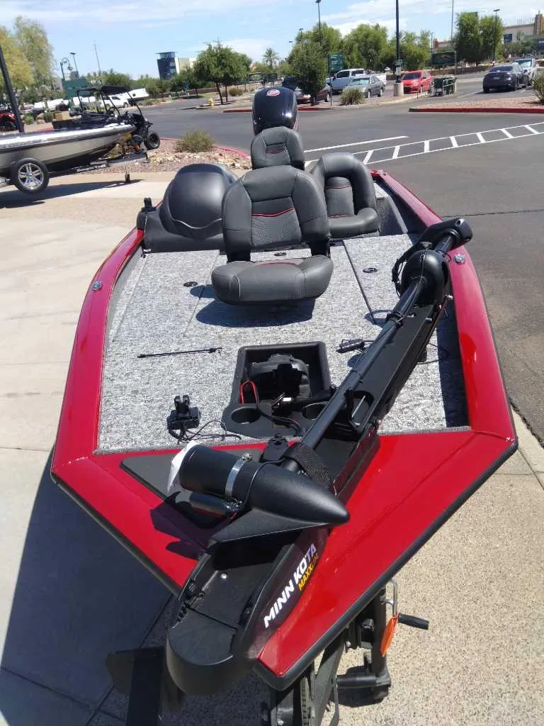 Slide: The Image of 2024 Tracker Pro Team 190 TX boat with red trim and Minn Kota trolling motor. - 3