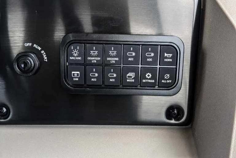 Slide: The Image of Control panel of 2024 Sun Tracker Party Barge 20 DLX with various switches and buttons. - 5