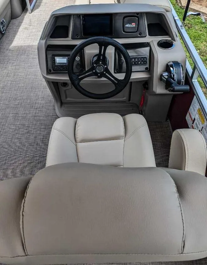 Slide: The Image of 2024 Sun Tracker Party Barge 20 DLX helm with steering wheel and control panel. - 6