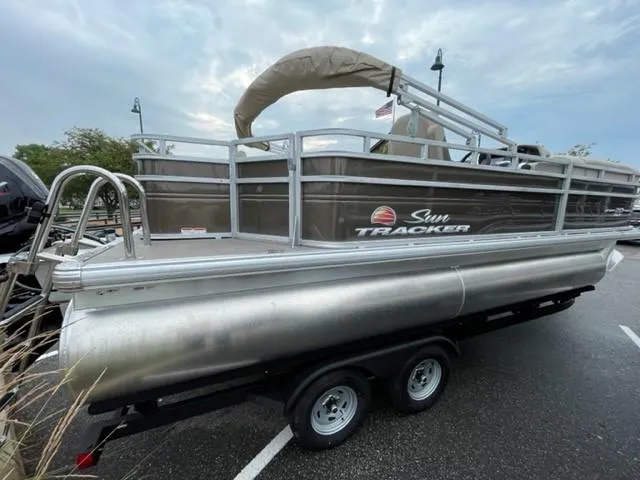 The Image of 2024 Sun Tracker SportFish 20 DLX pontoon boat on trailer, side view. - 0