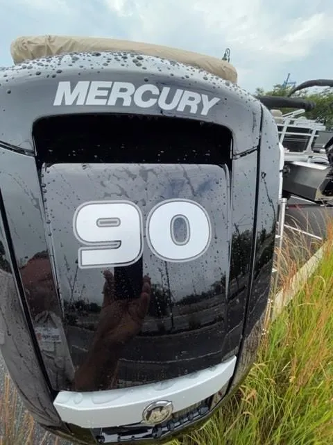 Slide: The Image of Mercury 90 horsepower engine on 2024 Sun Tracker SportFish 20 DLX boat, wet with raindrops. - 2