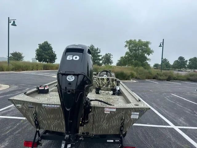 Slide: The Image of 2024 Tracker Grizzly 1754 SC boat with 50 HP engine in parking lot. - 5