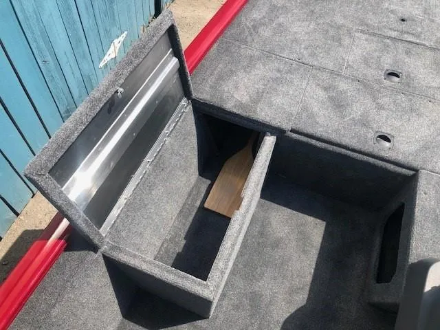 Slide: The Image of 2024 Tracker Pro 170 boat storage compartment with open lid. - 12