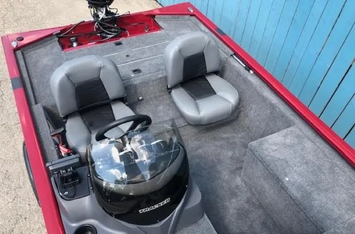 Slide: The Image of 2024 Tracker Pro 170 boat interior with gray seats and steering console. - 14