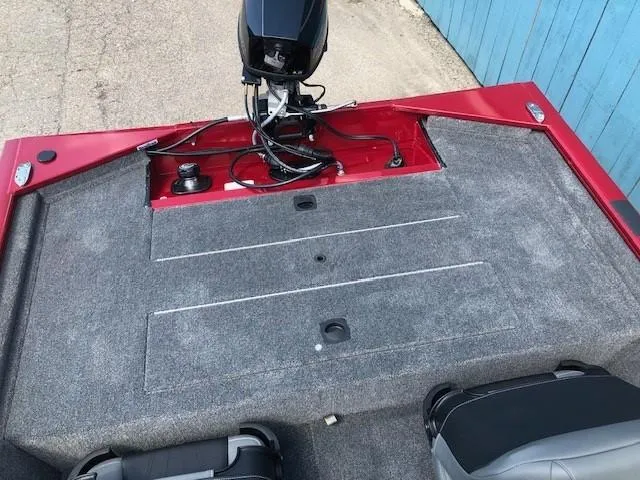 Slide: The Image of 2024 Tracker Pro 170 boat interior with motor and carpeted deck. - 18