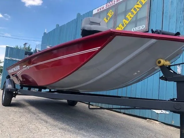 Slide: The Image of 2024 Tracker Pro 170 boat on trailer, red hull, side view. - 3
