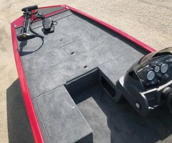 Slide: The Image of 2024 Tracker Pro 170 boat interior with red trim and gray carpet. - 7