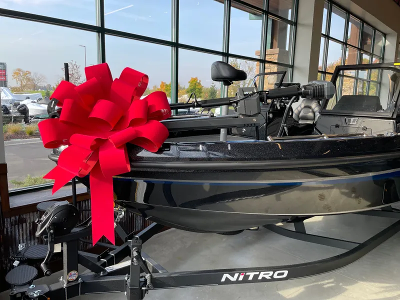 The Image of 2024 Nitro ZV21 boat with red bow on display in showroom. - 0