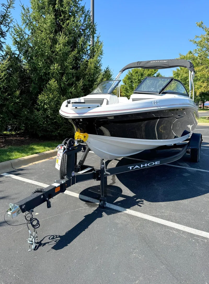 Slide: The Image of 2024 Tahoe 185 S boat on trailer in parking lot. - 2