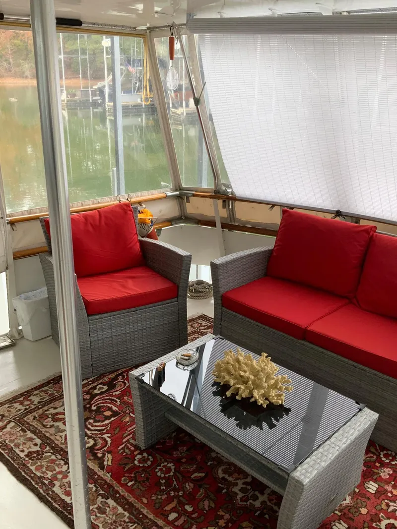 Slide: The Image of 1969 Hatteras 41 Double Cabin interior with red cushioned seating and glass table. - 24