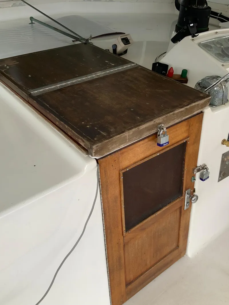 Slide: The Image of Wooden door on a 1969 Hatteras 41 Double Cabin boat with padlocks. - 25