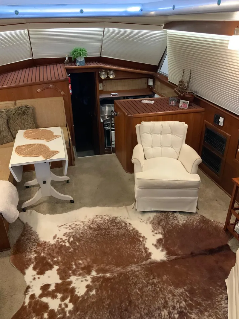 Slide: The Image of Interior of 1969 Hatteras 41 Double Cabin with cozy seating and cowhide rug. - 31