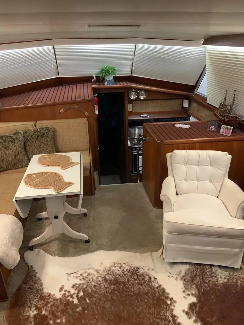 Slide: The Image of Interior of a 1969 Hatteras 41 Double Cabin yacht with cozy seating area. - 32