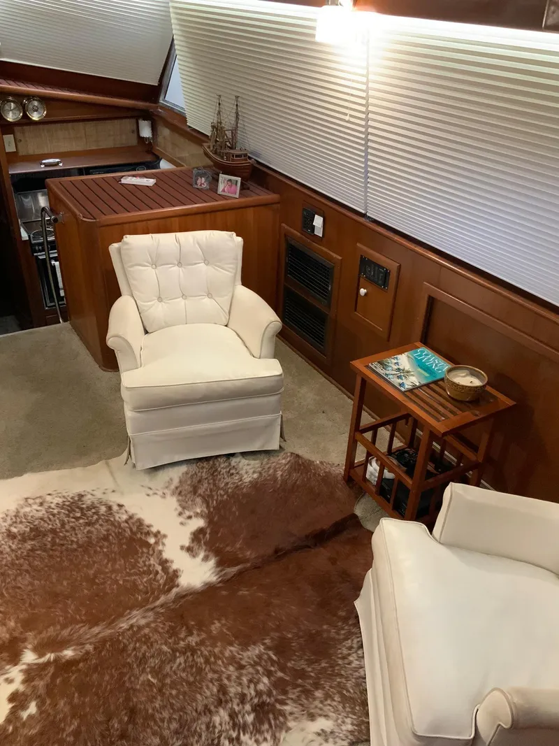 Slide: The Image of Interior of 1969 Hatteras 41 Double Cabin with white armchairs and cowhide rug. - 36