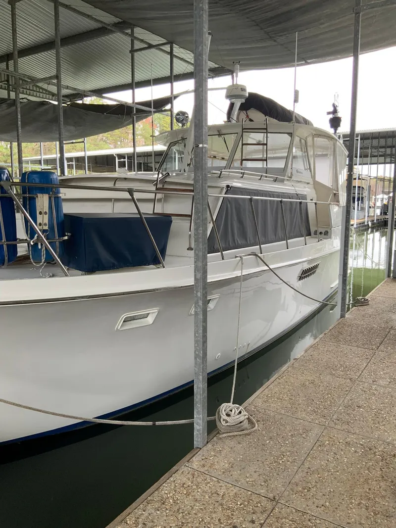 Slide: The Image of 1969 Hatteras 41 Double Cabin yacht docked in a covered marina. - 4