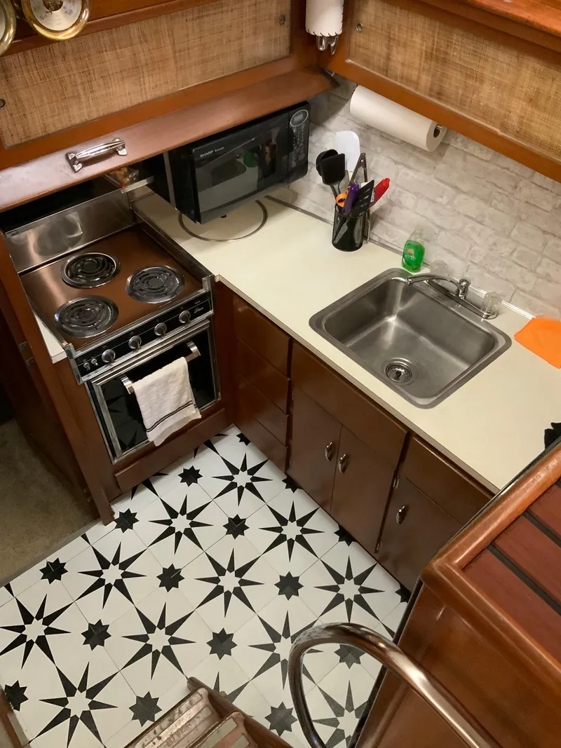 Slide: The Image of 1969 Hatteras 41 Double Cabin kitchen with stove, sink, and microwave. - 40