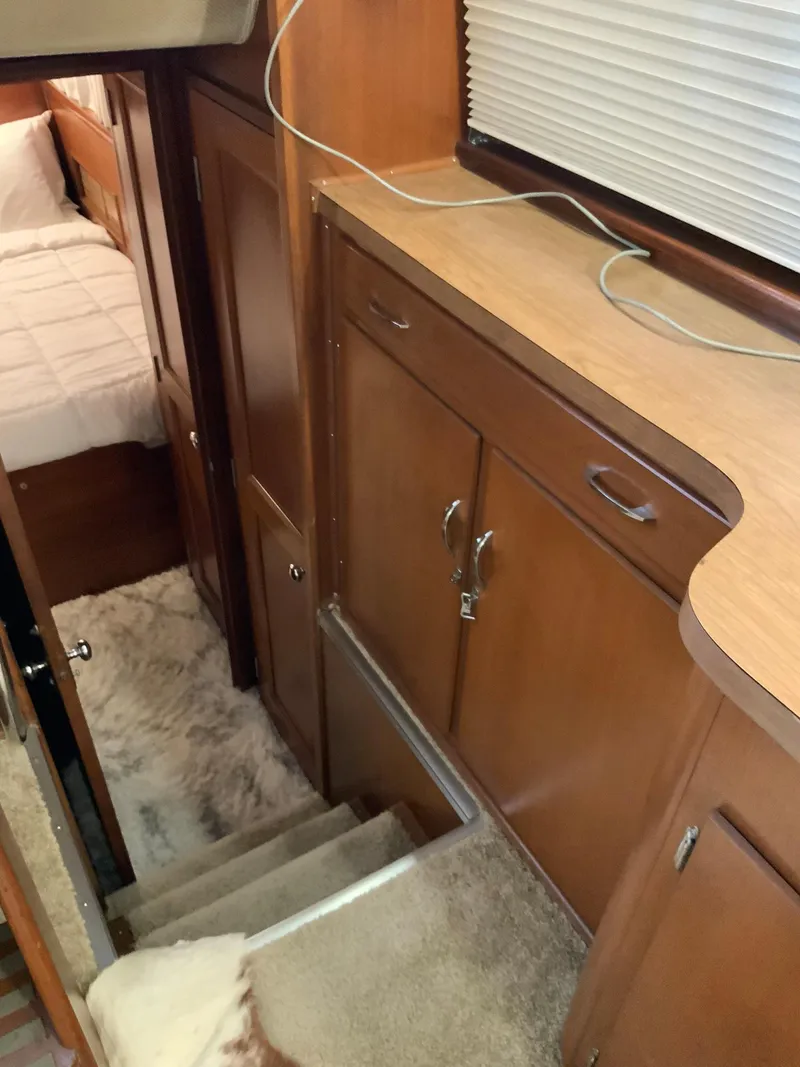 Slide: The Image of 1969 Hatteras 41 Double Cabin interior with wooden cabinetry and carpeted stairs. - 45