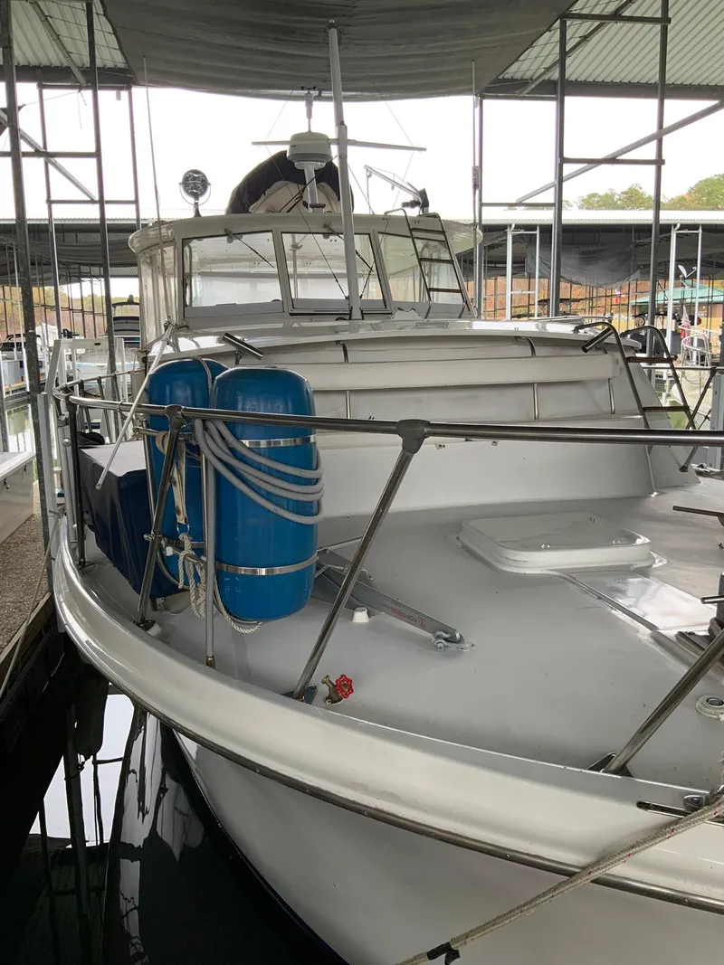 Slide: The Image of 1969 Hatteras 41 Double Cabin yacht docked in a covered marina. - 8