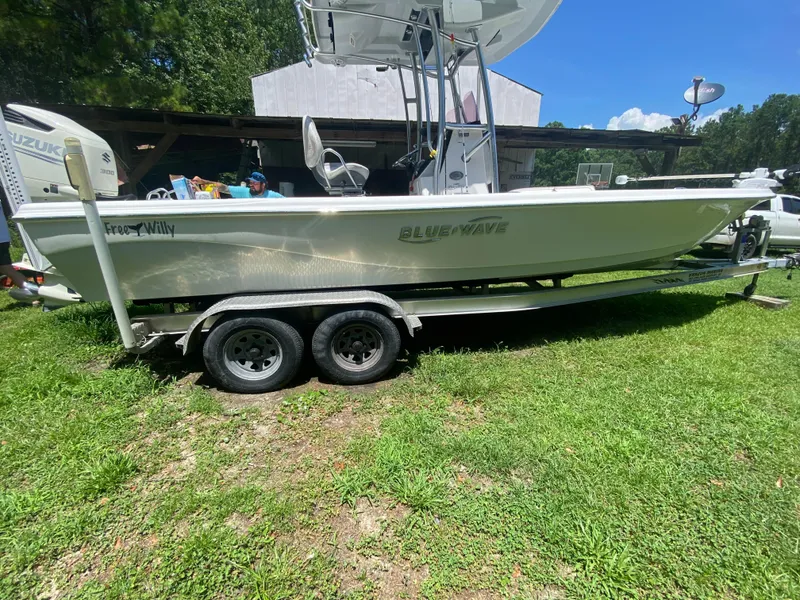 Slide: The Image of 2019 Blue Wave 2400 PureBay boat on a trailer in a grassy yard. - 17