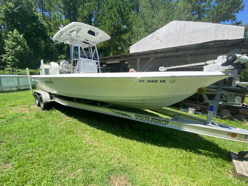 Slide: The Image of 2019 Blue Wave 2400 PureBay boat on a trailer in a grassy yard. - 18