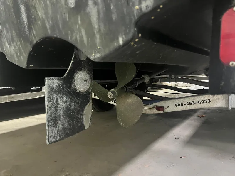 Slide: The Image of Propeller and rudder of a 1976 SeaCraft 23 Classic boat on a trailer. - 11