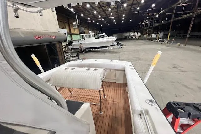 Slide: The Image of 1976 SeaCraft 23 Classic boat in a spacious indoor storage facility. - 3